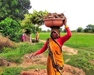 Woman with trees on her head in India